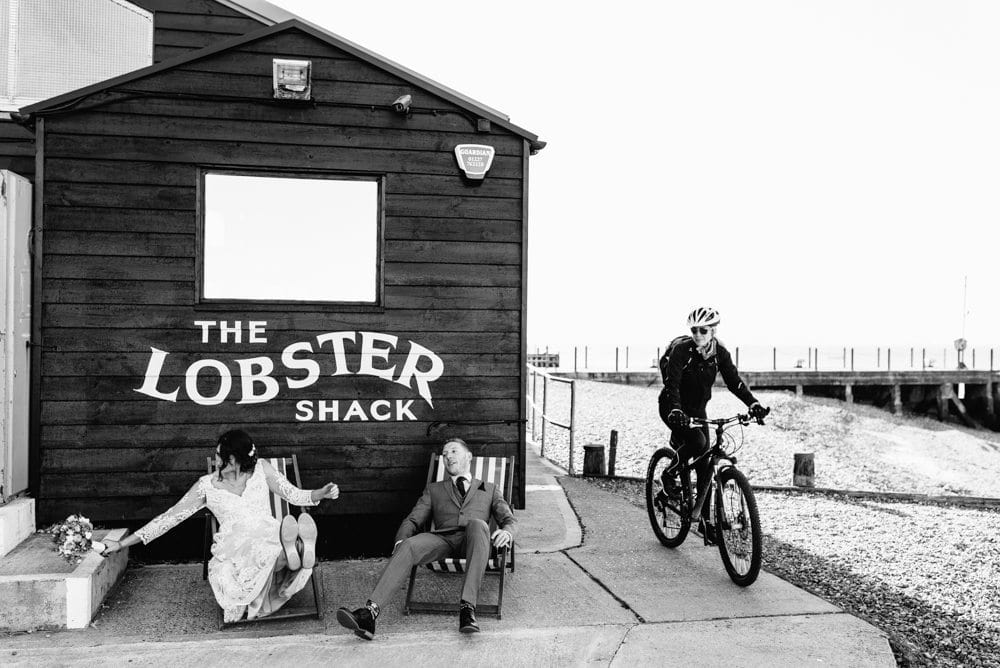 bride and groom sitting in deckchairs at east quay wedding venue in kent