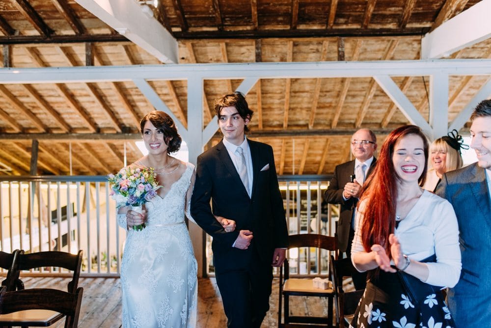 bride walking down aisle at east quay whitstable in kent