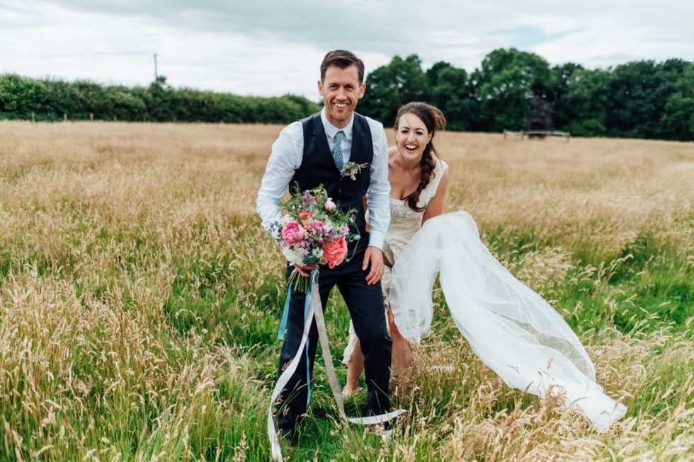bride and groom portrait in a field at outdoor farm wedding