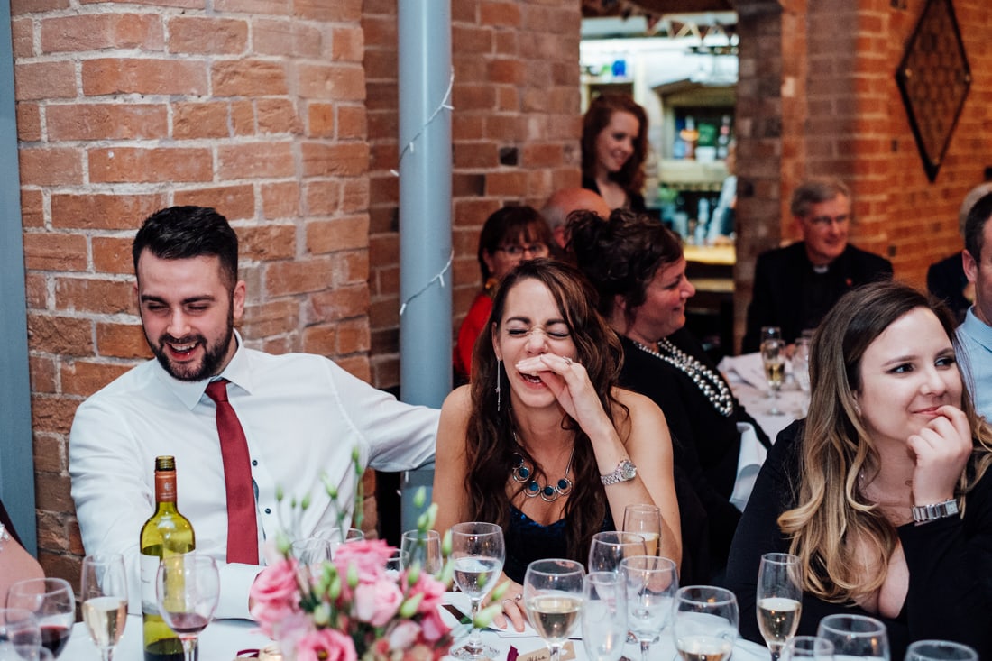 wedding guest laughing at speeches