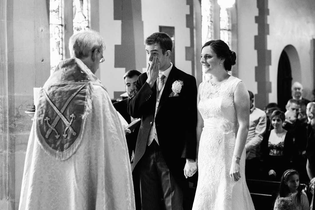 bride and groom at the church with the groom crying