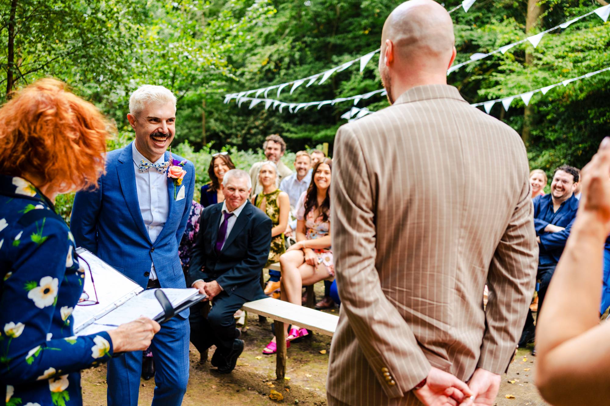 A bride and groom standing on the stairs of a building.