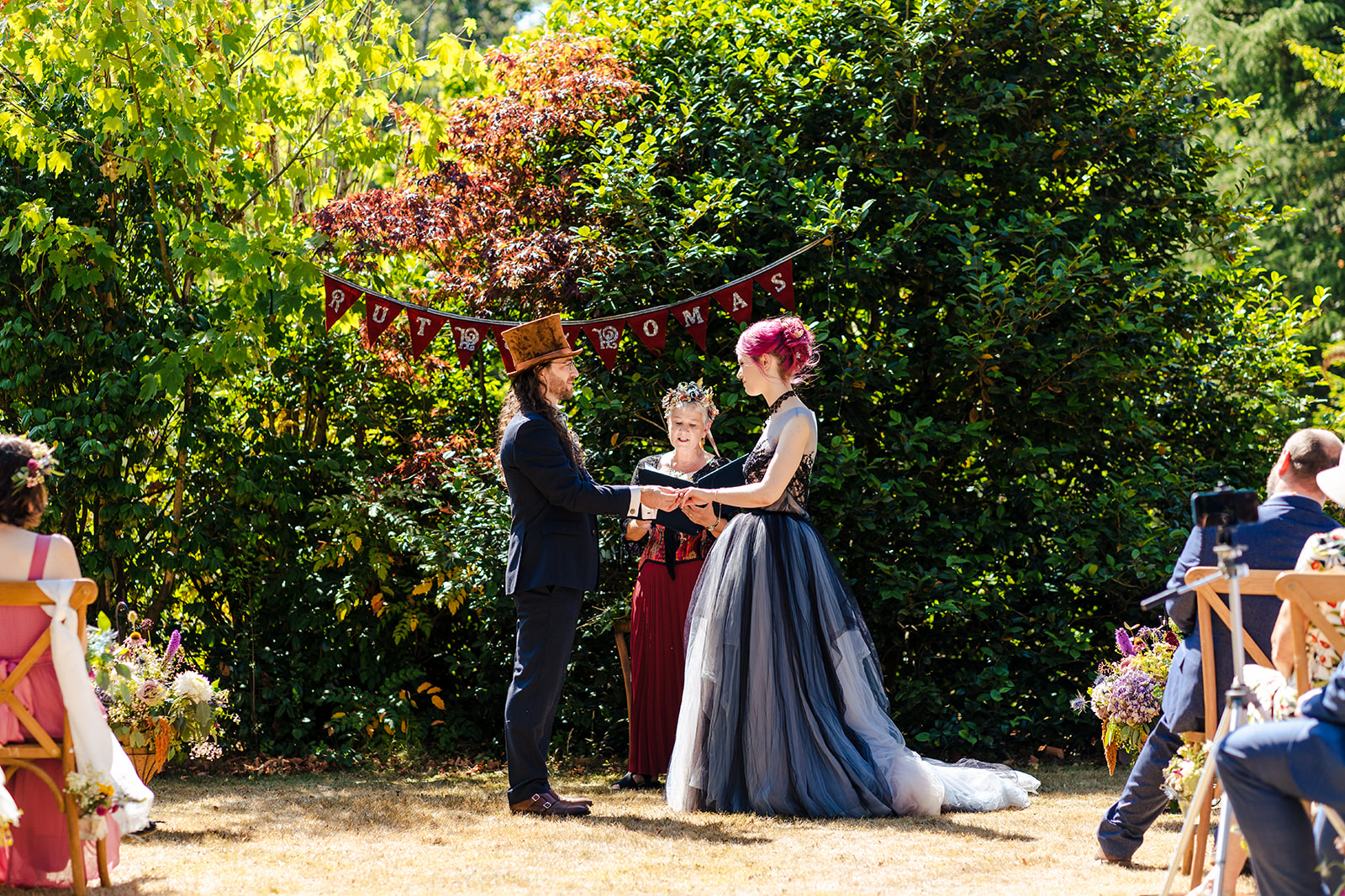 A bride and groom standing on the stairs of a building.
