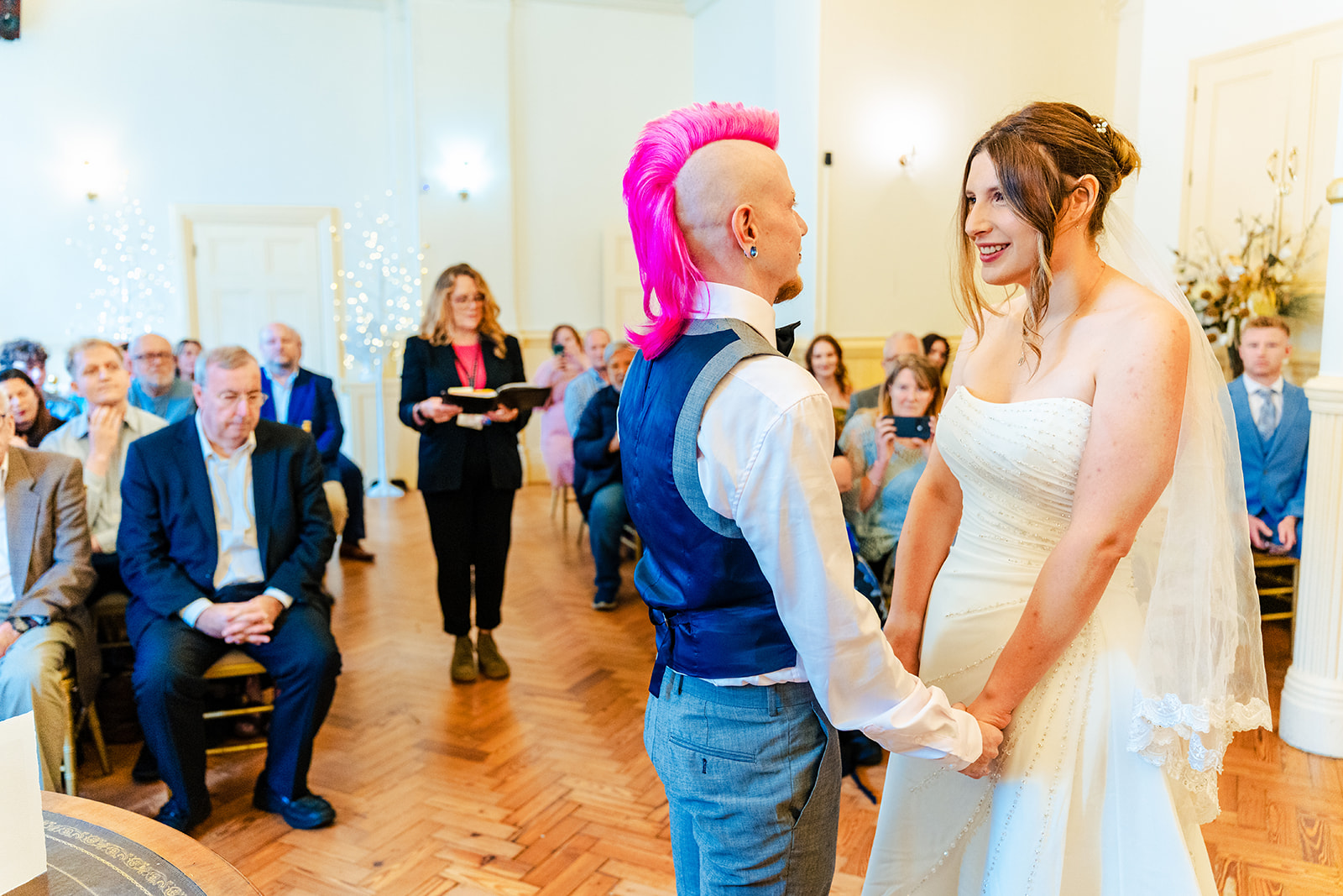A bride and groom standing on the stairs of a building.