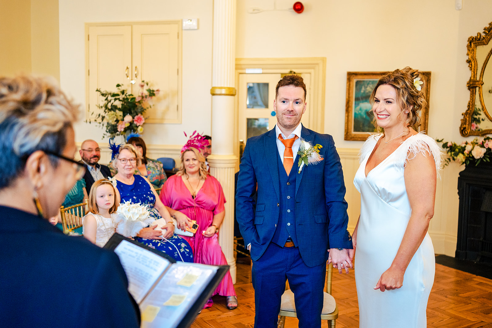 A bride and groom standing on the stairs of a building.