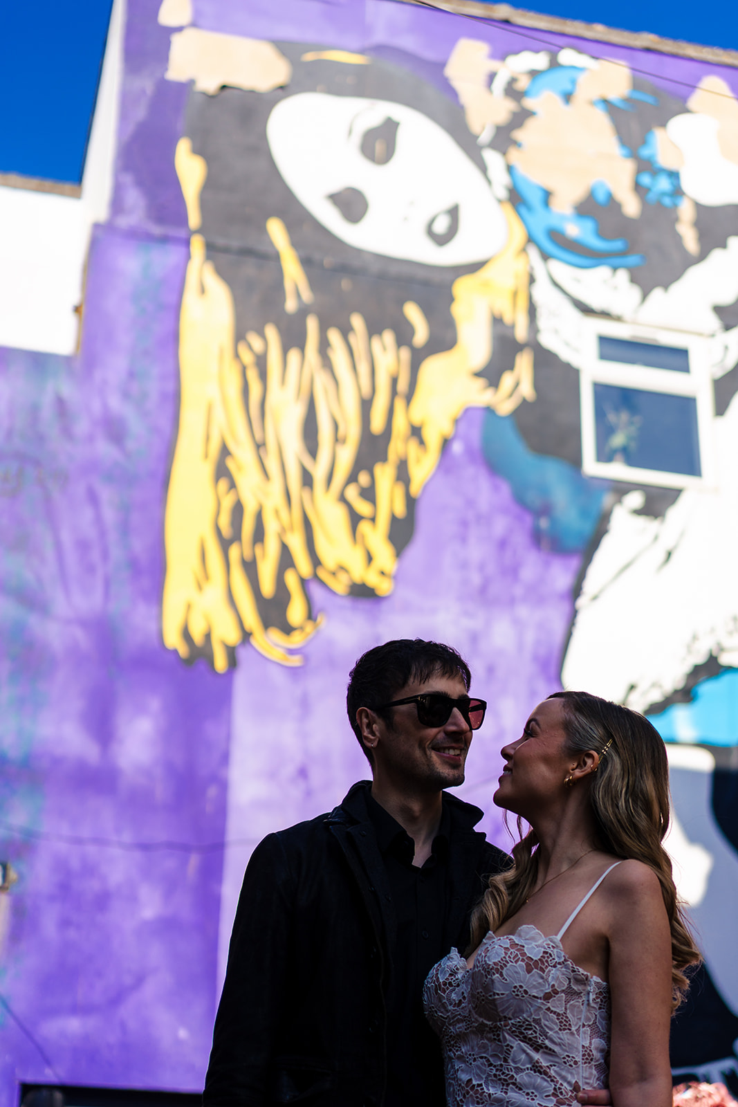 Joe and Amanda by street art in Brighton