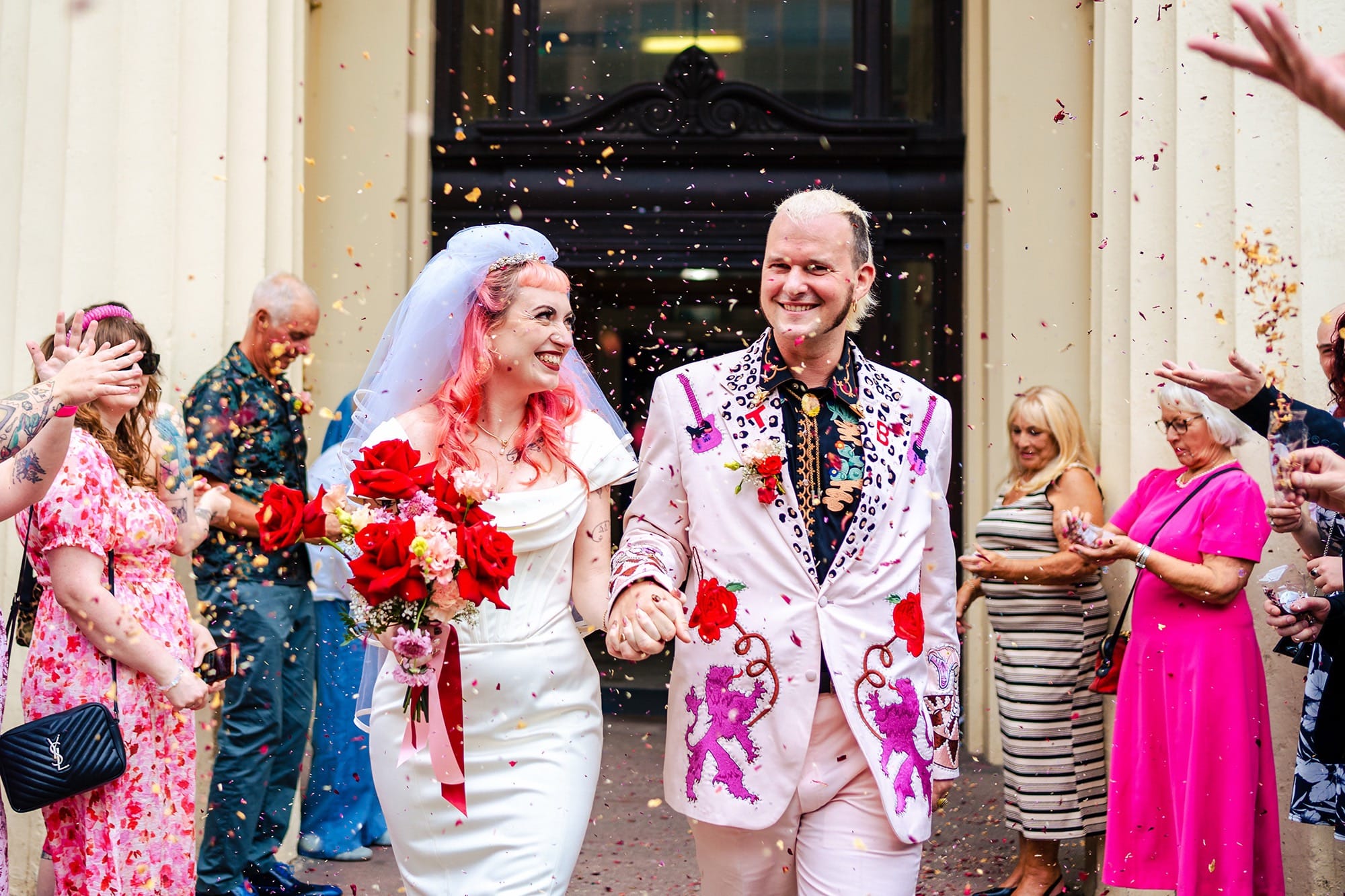 A couple laughing at their wedding reception, surrounded by rustic wilderness.