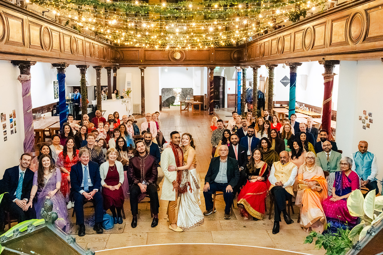 A bride and groom standing on the stairs of a building.