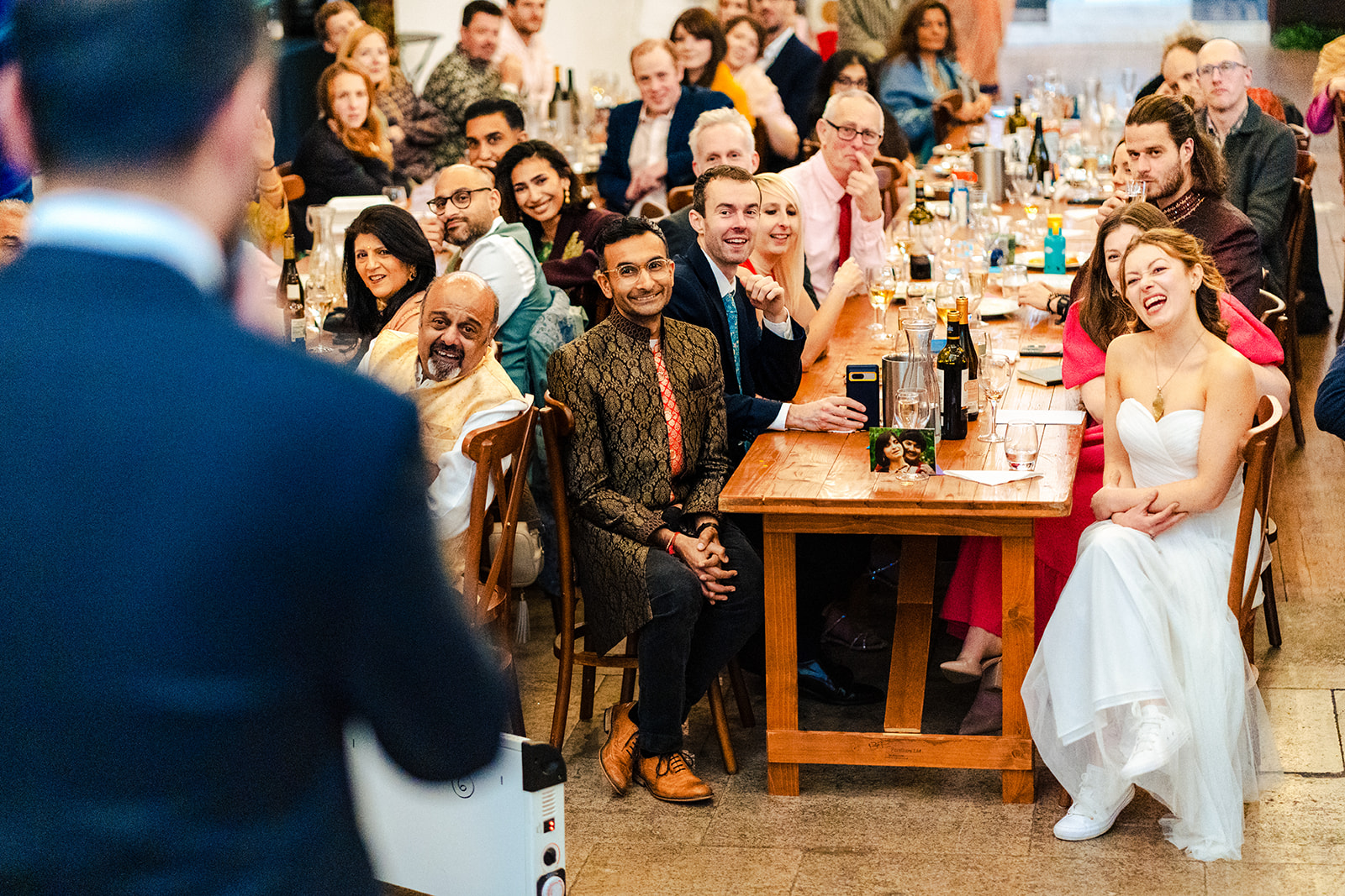 A bride and groom standing on the stairs of a building.