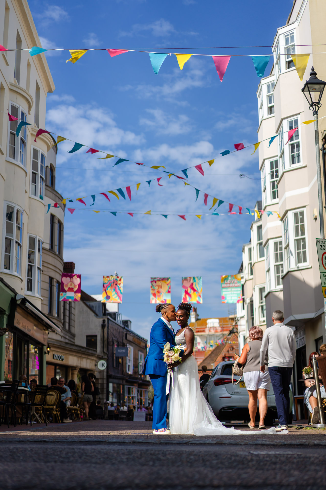 Couple portrait on a Brighton street with bunting