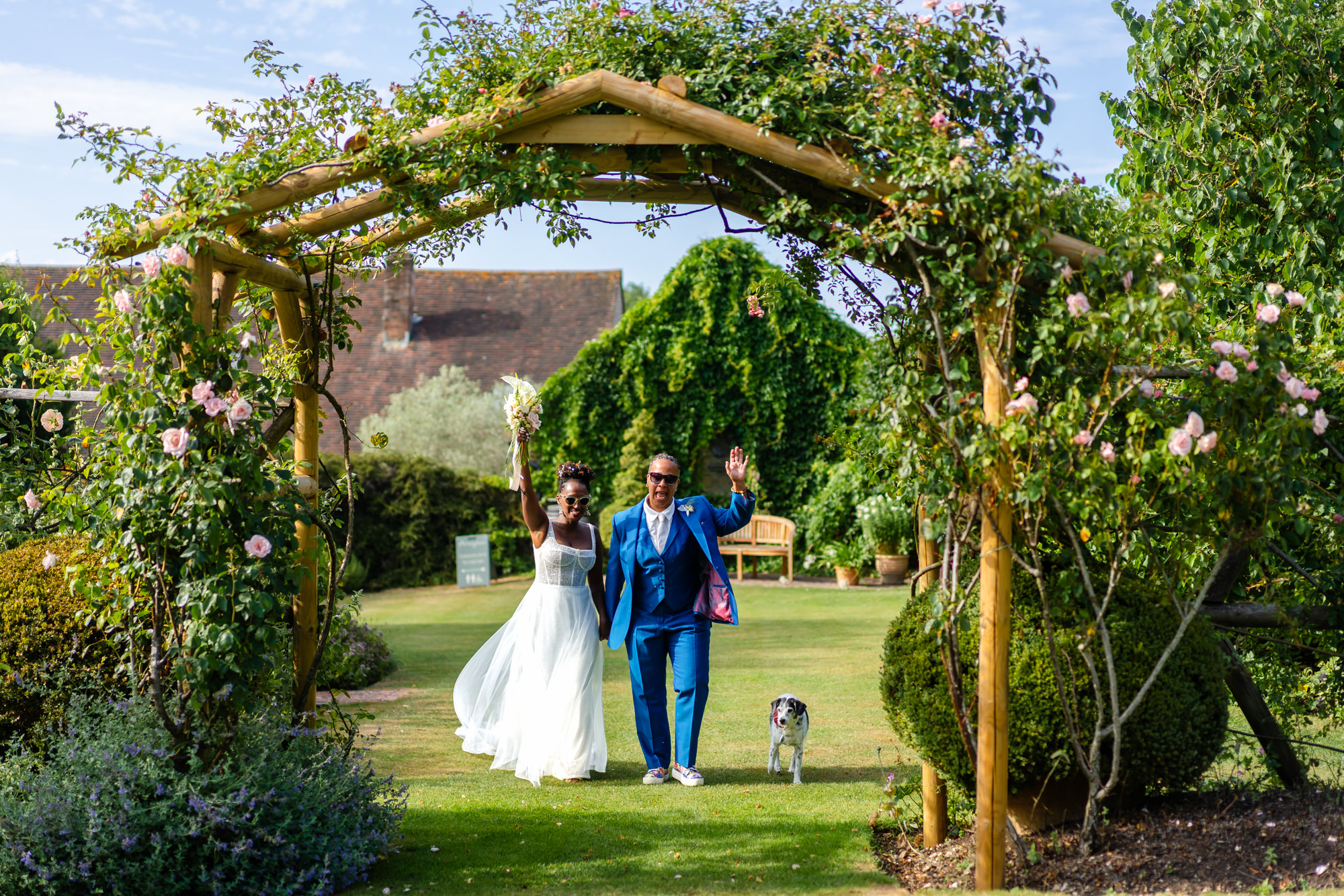 Couple portrait under a floral arch in the garden