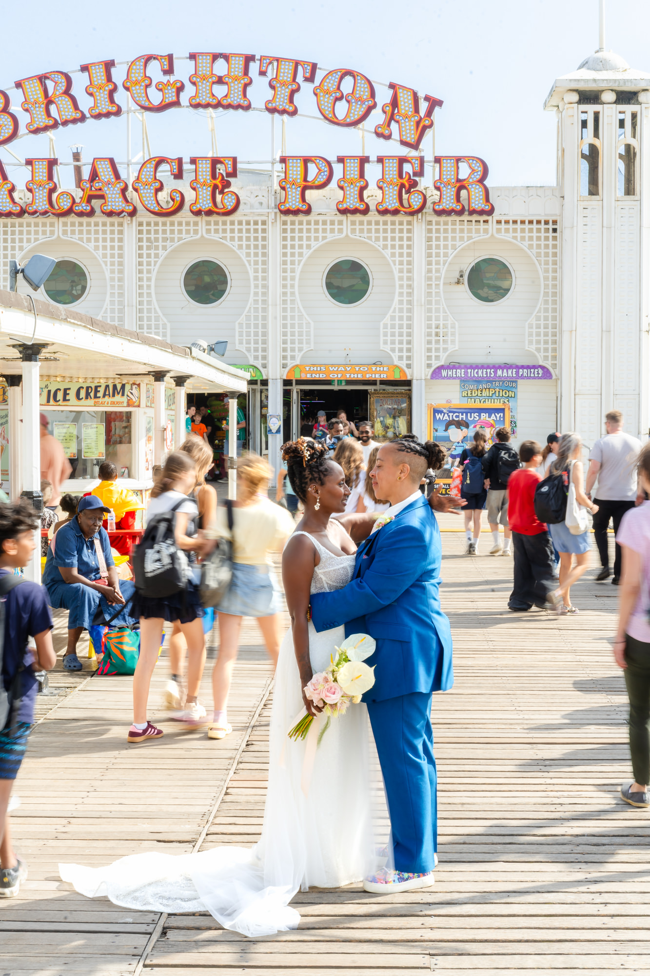 Azieb and Jules under the Brighton Palace Pier sign