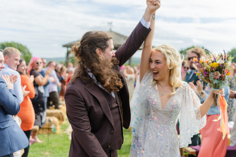 Bride and groom cheering at their Yoghurt Rooms wedding