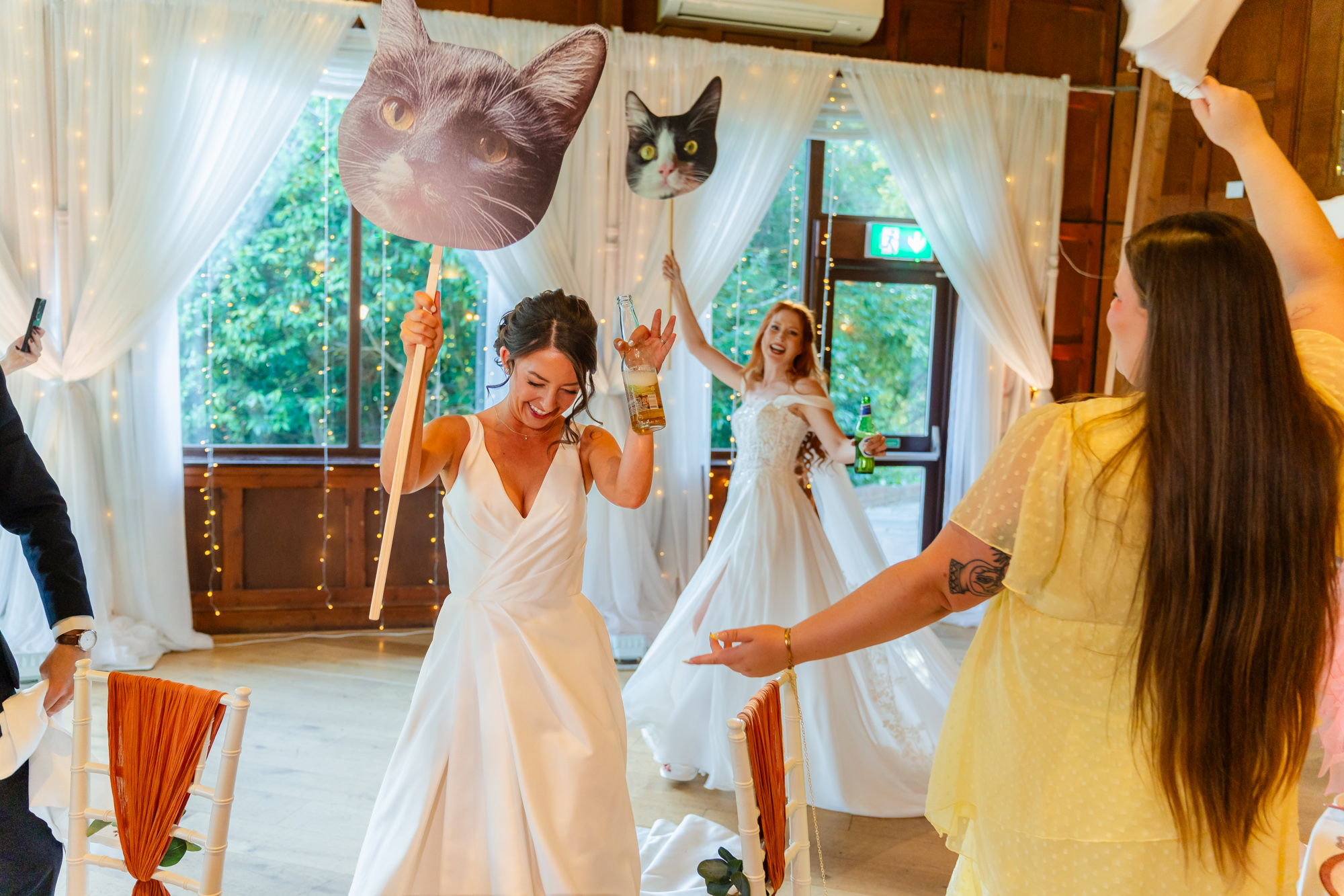 The Ravenswood Amy and Chloe dancing with giant cat heads at The Ravenswood