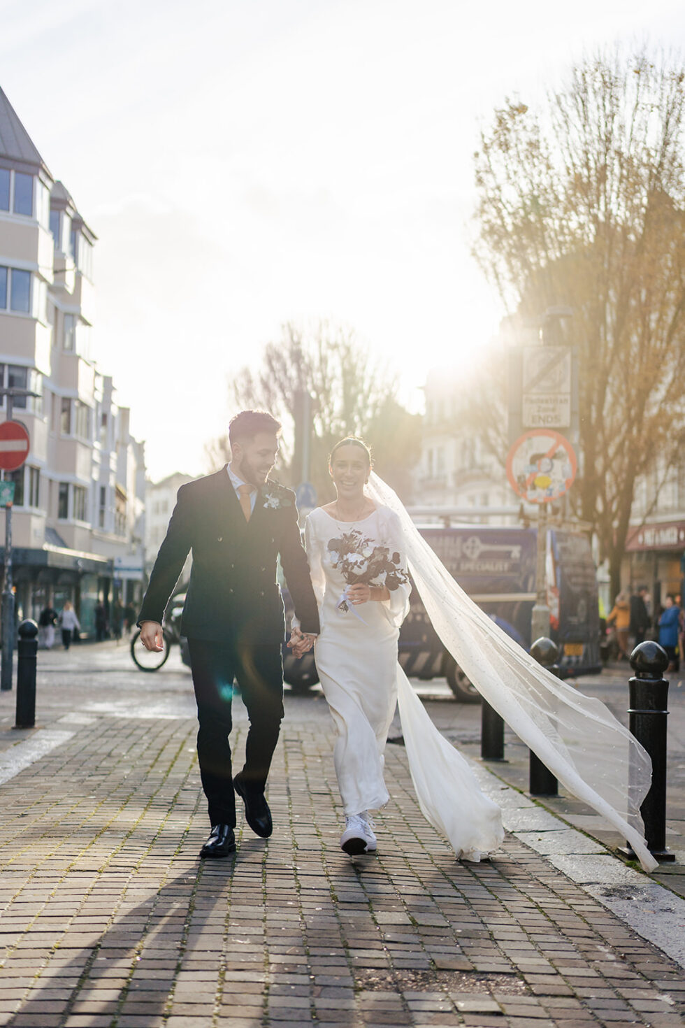 Sophie and Ed's sunset portrait in Brighton, veil catching the light
