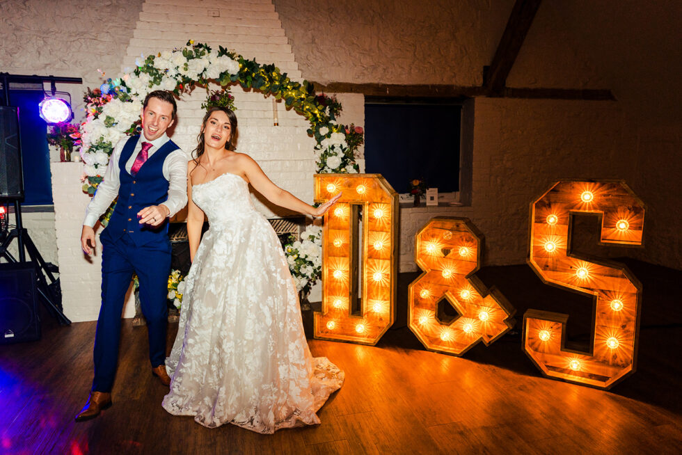 Steph and David dancing by the light-up letters